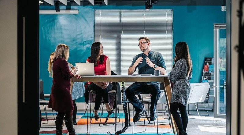 A group of Waterstons staff members in conversation.